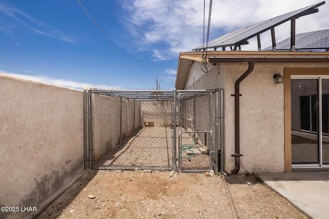 2230 Havasupai Blvd, Lake Havasu City, AZ 86403 - view of property exterior featuring stucco siding, a gate, and solar panels