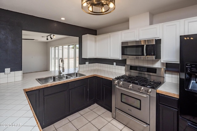 2230 Havasupai Blvd, Lake Havasu City, AZ 86403 - kitchen with appliances with stainless steel finishes, a sink, tile countertops, white cabinets, and light tile patterned flooring