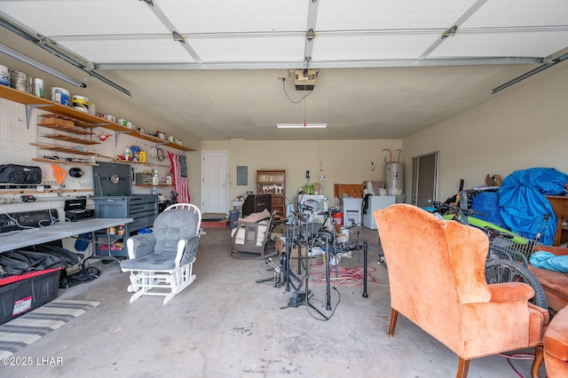 garage featuring water heater, a workshop area, electric panel, and a garage door opener