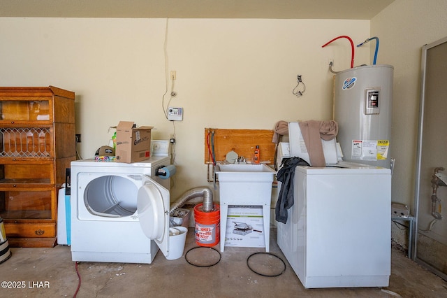 laundry area with laundry area, electric water heater, and washer and dryer