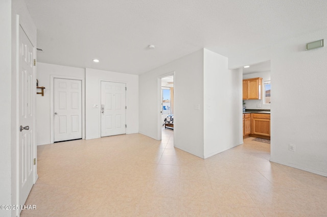 unfurnished room featuring recessed lighting, visible vents, and baseboards