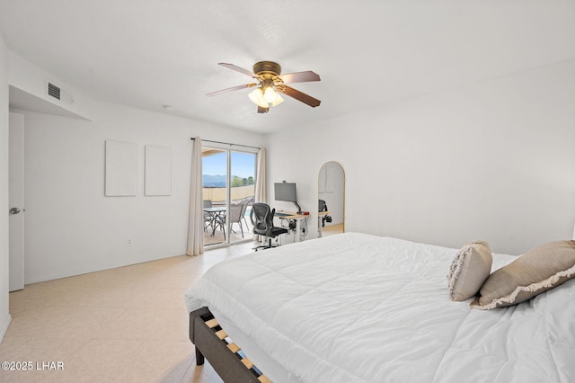 bedroom featuring arched walkways, visible vents, a ceiling fan, and access to exterior