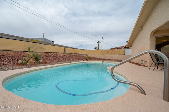 view of swimming pool featuring a fenced in pool