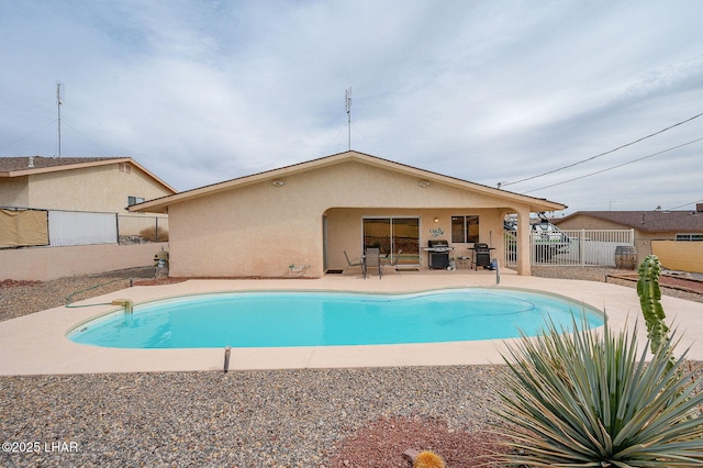 view of pool featuring a fenced in pool, a fenced backyard, a patio, and area for grilling