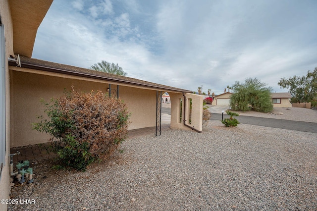 back of property with an outbuilding and stucco siding