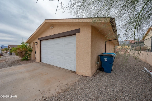 garage featuring concrete driveway