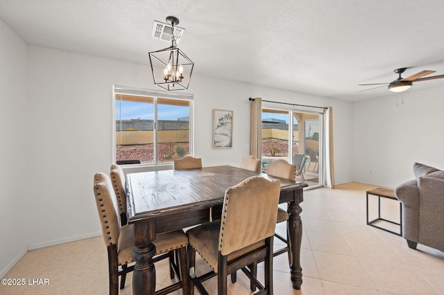 dining space featuring a textured ceiling, plenty of natural light, and visible vents