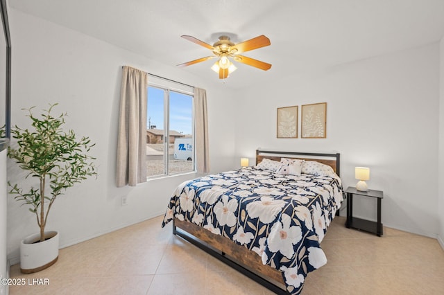 bedroom featuring tile patterned flooring, baseboards, and ceiling fan