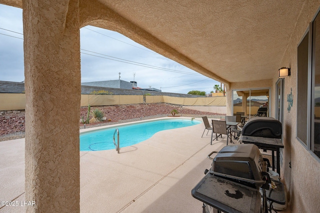 view of swimming pool featuring a fenced backyard, a fenced in pool, and a patio