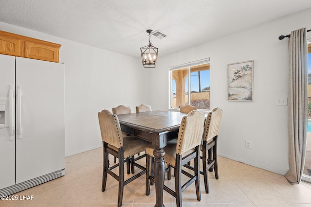 dining room with baseboards, visible vents, a notable chandelier, and light tile patterned flooring