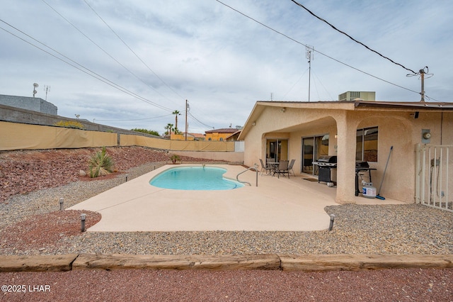 view of swimming pool with a patio, a fenced backyard, a fenced in pool, and a grill