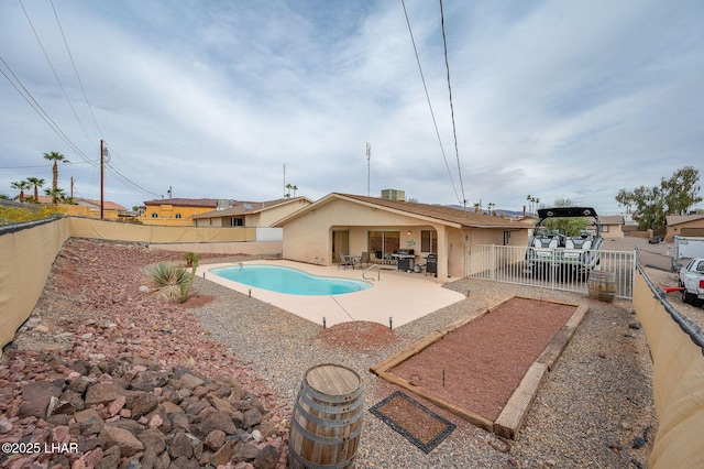 view of swimming pool featuring a patio area, a fenced backyard, a fenced in pool, and cooling unit