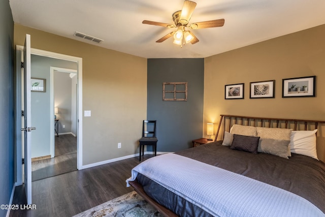 bedroom with dark wood-style floors, visible vents, ceiling fan, and baseboards