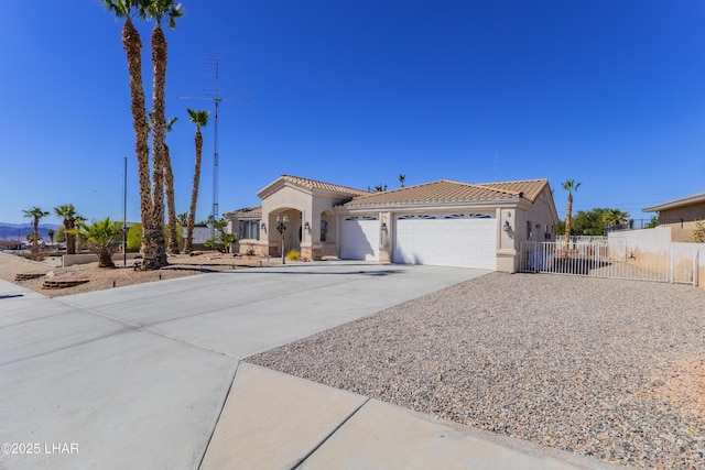 mediterranean / spanish house featuring driveway, a tile roof, an attached garage, fence, and stucco siding