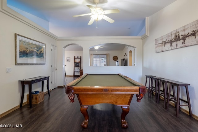 rec room with arched walkways, ceiling fan, pool table, baseboards, and dark wood finished floors