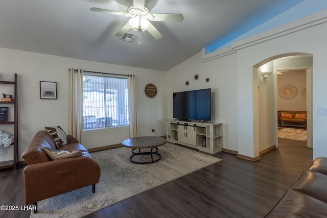 living area featuring arched walkways, dark wood finished floors, lofted ceiling, visible vents, and a ceiling fan