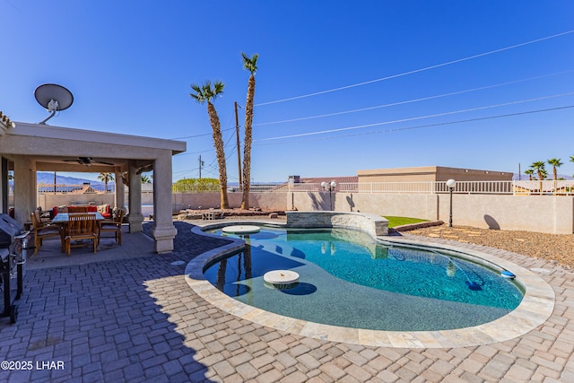 view of swimming pool featuring a ceiling fan, a patio area, a fenced backyard, and a fenced in pool