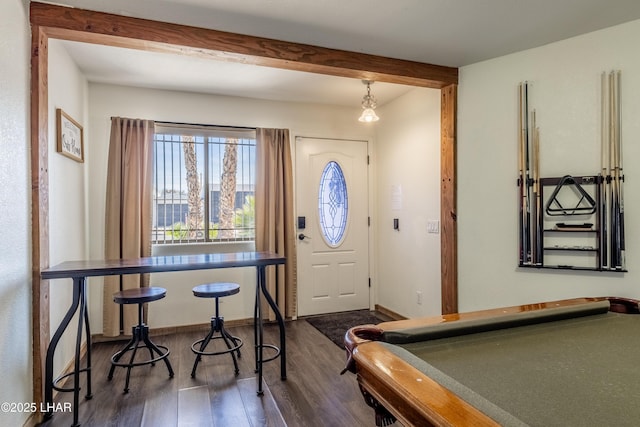 entrance foyer featuring billiards, beam ceiling, baseboards, and dark wood-type flooring