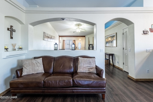 living room featuring dark wood finished floors, baseboards, and ceiling fan