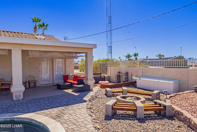 view of patio / terrace featuring an outdoor living space with a fire pit and fence