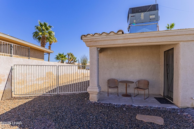 view of yard featuring a patio, fence, and central AC unit