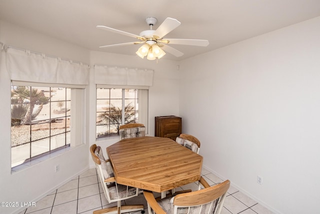 dining room with ceiling fan, baseboards, and light tile patterned floors