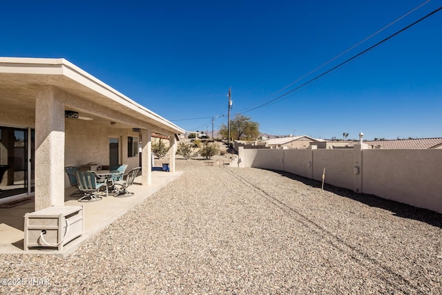 view of yard featuring fence and a patio