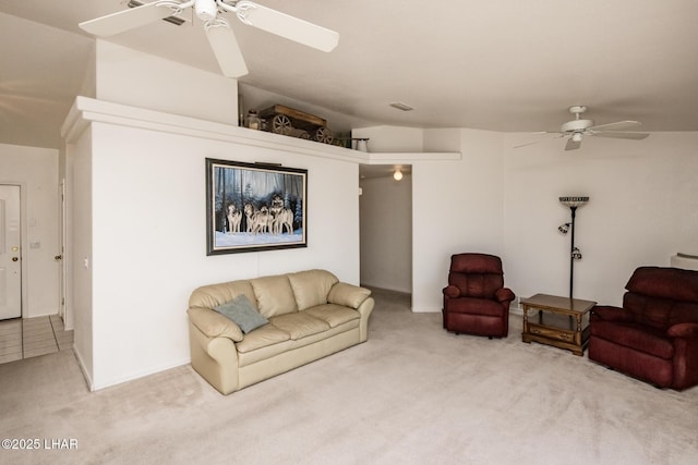 carpeted living area featuring a ceiling fan