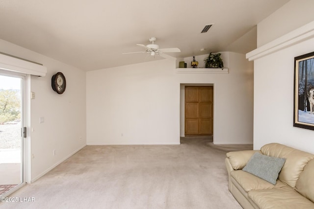 unfurnished living room featuring ceiling fan, light colored carpet, visible vents, baseboards, and vaulted ceiling