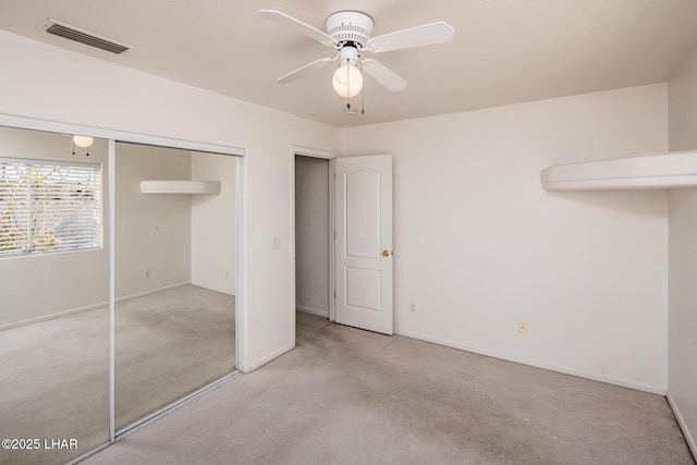 unfurnished bedroom featuring a closet, visible vents, carpet flooring, ceiling fan, and baseboards