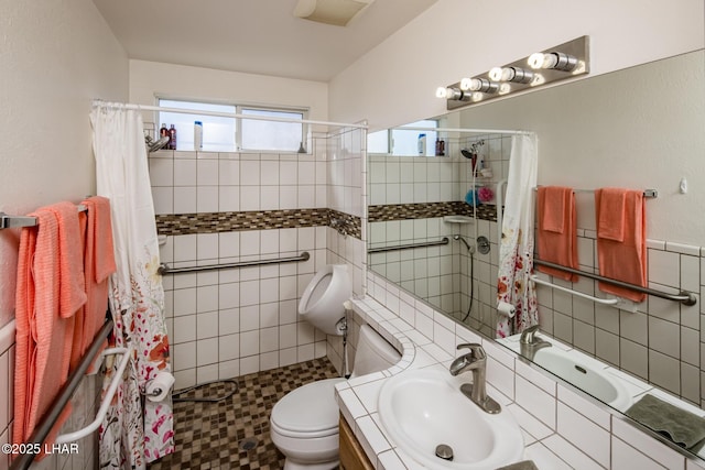 full bathroom with vanity, a shower stall, toilet, and tile walls