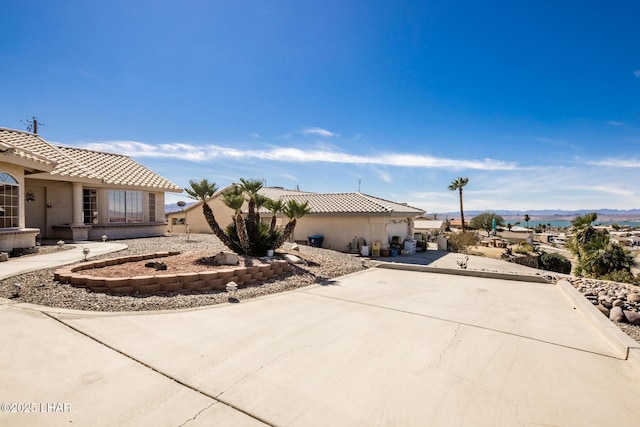 view of property exterior featuring a tiled roof and stucco siding