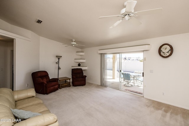 living room featuring a ceiling fan, carpet, visible vents, and baseboards