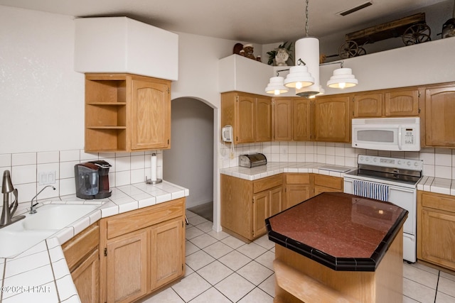 kitchen with arched walkways, light tile patterned floors, open shelves, visible vents, and white appliances