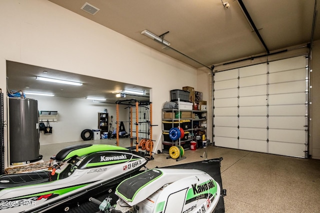 garage featuring visible vents and water heater