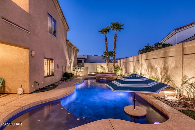 view of pool featuring a patio, a pool with connected hot tub, and a fenced backyard