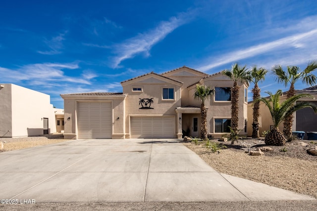 view of front of home featuring a tile roof, a garage, driveway, and stucco siding