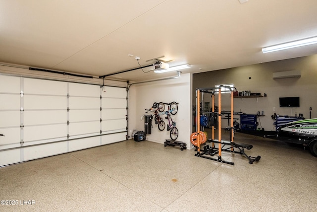 garage featuring a garage door opener and a wall unit AC