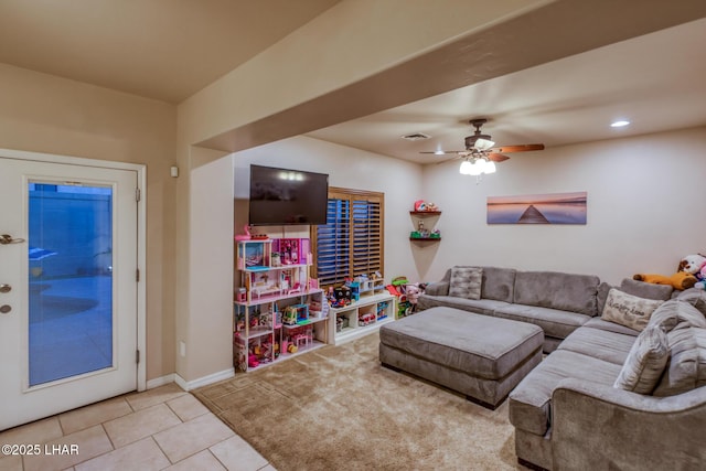 living room featuring baseboards, a ceiling fan, and tile patterned flooring