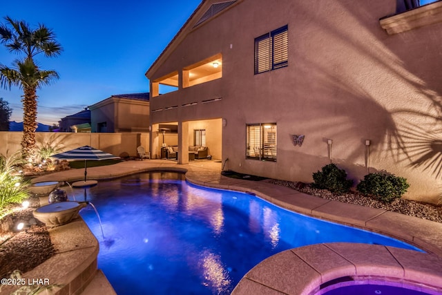 view of swimming pool with an in ground hot tub, fence, a fenced in pool, and a patio