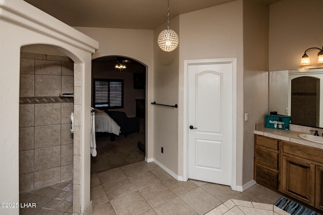 full bath with tiled shower, ensuite bath, vanity, and tile patterned flooring