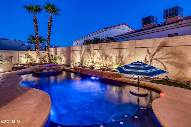 view of swimming pool featuring a fenced backyard, a pool with connected hot tub, and central AC