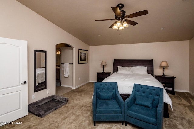 bedroom with lofted ceiling, baseboards, arched walkways, and light carpet