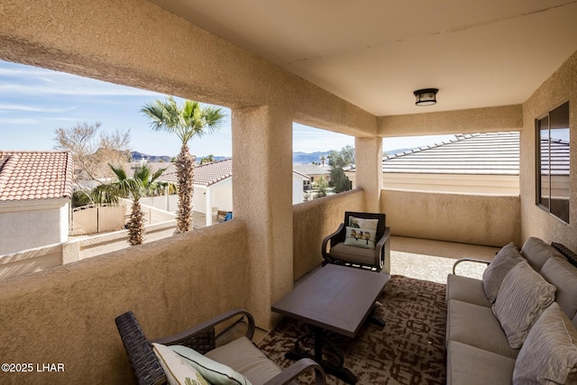 balcony featuring an outdoor living space and a residential view