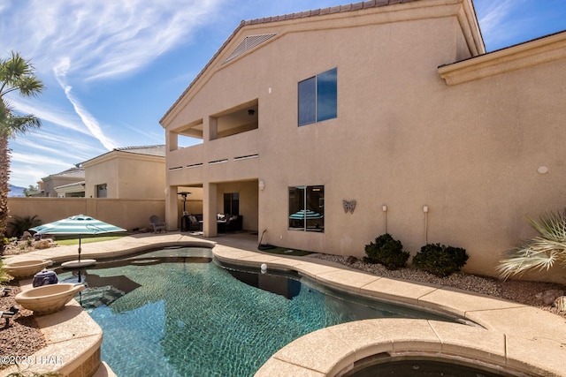 view of pool featuring a fenced in pool, fence, an in ground hot tub, and a patio area