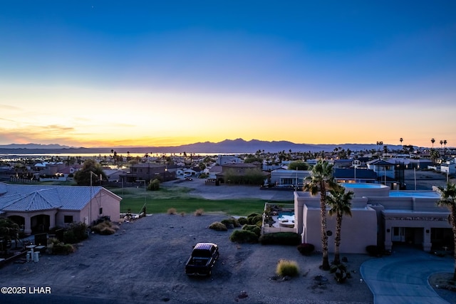 aerial view at dusk featuring a residential view