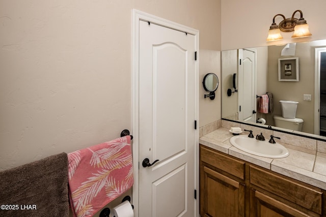 bathroom featuring toilet and vanity