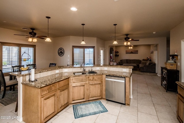 kitchen with a sink, open floor plan, stainless steel dishwasher, and ceiling fan