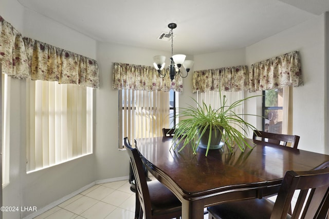 tiled dining area with an inviting chandelier