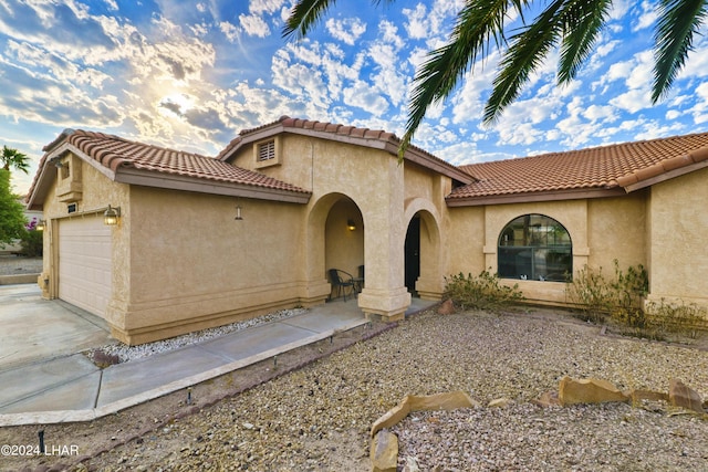 mediterranean / spanish home with a garage